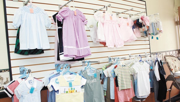 Among the items in the the newly opened consignment store are gently worn heirloom dresses and smocked outfits for boys.