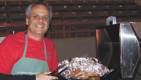 Jeff Grimes cooks up eats at a previous wildgame cookoff.  | File photo