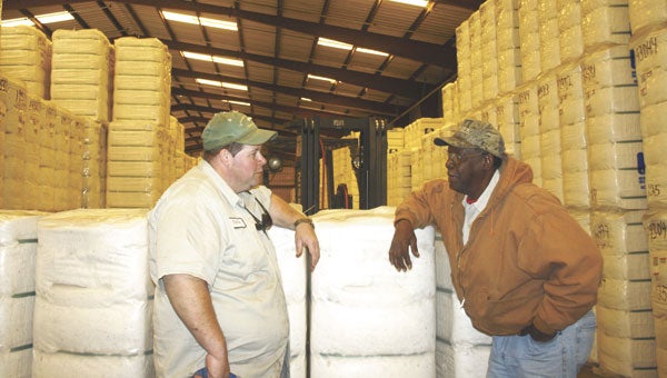 Kevin Gomillion and Cecil Blue discuss stacking procedure inside one of the gin’s many warehouses.  
