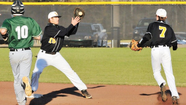 Opp’s Ethan Davis (15) catches a short throw from second-baseman Chase Robbins (7) for an out Monday night in the Bobcats’ win over Flomaton. |                                                                                 Andrew Garner/Star-News