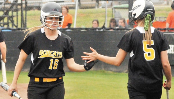 Opp’s Cayla Hughes (16) gives a five to Courtney Chatham during an earlier game. | Andrew Garner/Star-News