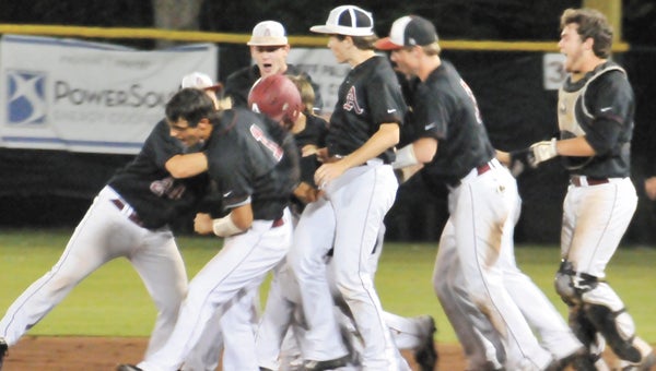 Andalusia baseball players celebrate with Brayden Burkhardt after the sophomore laid down a bunt that scored the game-winning run in the bottom of the seventh inning Friday night. |                             Andrew Garner/Star-News