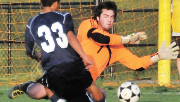 Andalusia’s Chris Smith (right) makes a save during the first half Monday night. | Andrew Garner/Star-News