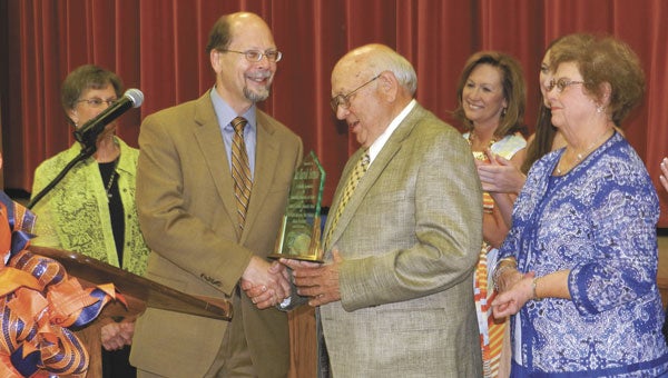Dr. Herb Riedel presents Harold Sorrells with a plaque. Standing behind Sorrells are his oldest daughter, Missy Mims, and wife, Jeanette Sorrells.| Michele Gerlach/Star-News
