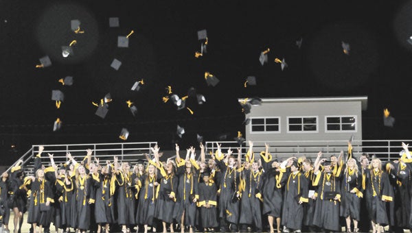 The Opp HIgh School Class of 2013 tosses their hats after graduation. 