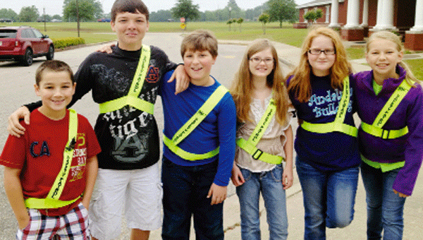 Called the “safety patrol,” these fifth grade Andalusia Elementary School students – Carley Wallace, Michael Jordan, Chloe Mikel, Alexa Linquest, Caleb Smallwood and Fletcher Ament – are on hand with smiles and safety vests.
