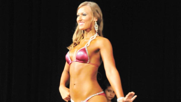 Cassie Cooper competes in the amateur bikini event Saturday night. | Andrew Garner/Star-News