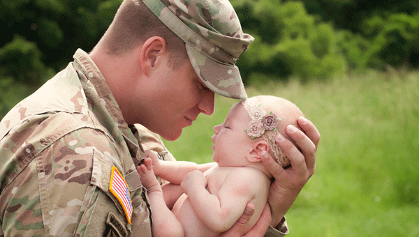 SSG Davin Hand and his newborn daughter, Aurora. Photo courtesy of Kelly Young/Lolak’s Photography