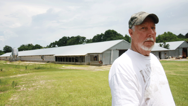 Alan Jackson stands in front of his two laying hen houses in the Horn Hill Community. Jackson’s Yellow River Poultry Farms is one nearly 1,100 farms in the county. 