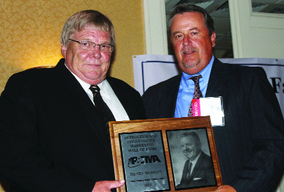 Rick Morgan of Opp accepts the state Petroleum and Convenience Marketing Hall of Fame honor on behalf of his late father, Henry Morgan. Giving the honor is Shayne Lord,  P&CMA president and Opp businessman. 