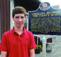 Jacob Peek is spending his summer working at the Three Notch Museum, which is sporting a new roof. He is shown here in front of a newly-installed historic marker, a gift to the museum from G. Sidney Waits. The museum is open Tuesday, Wednesday and Thursday mornings from 8 until noon. 