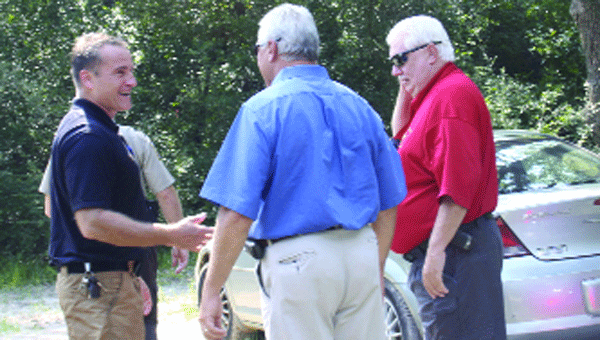 Sheriff Dennis Meeks, Chief Deputy David Anderson and others discuss the recovery effort Tuesday.                        