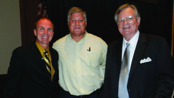 Coach Jim Johnson with Superintendent Ted Watson and Mayor Earl Johnson at Monday night’s public event.   