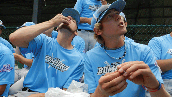 Tyler Kryzanowski and Logan Mertens of the Fond Du Lac, Wis., Bombers, enjoy boiled peanuts before their Friday afternoon game.