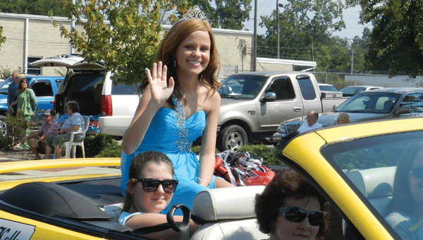 Megan Kelley waves to the crowd during last year's homecoming parade. She was in the hospital in Birmingham on homecoming morning, when she learned she had been elected queen. She made it to Andalusia in time to ride in the parade and participate in pre-game activities.