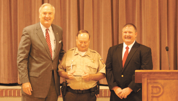 School Resource Officer Joe Schneider, pictured with Pleasant Home Principal Craig Nichols, smiles at the  school safety award he received from Attorney General Luther Strange Thursday.