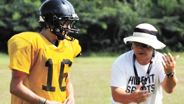 Red Level coach David Godwin (right) instructs during an earlier practice this season. The Tigers hope to win Friday night against Prattville Christian. | File photo