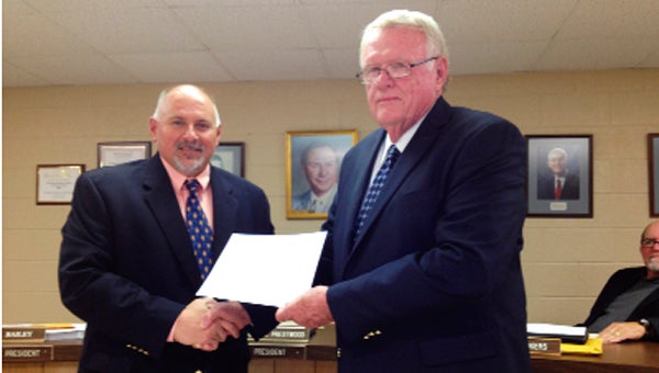 New County School Board President Jeff Bailey congratulates board member Sonny Thomasson on achieving level I in the Alabama Association of School Board’s Academy during the 2012-2013 academic year.