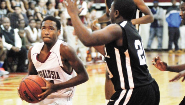 Andalusia’s Jayden Eillison (left) drives to the bucket Thursday night during the Bulldogs’ 61-28 win over Red Level to start its annual invitational tournament. | Andrew Garner/Star-News