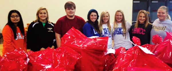 LBWCC students take a break from helping with packaging for the Andalusia Community Christmas event.