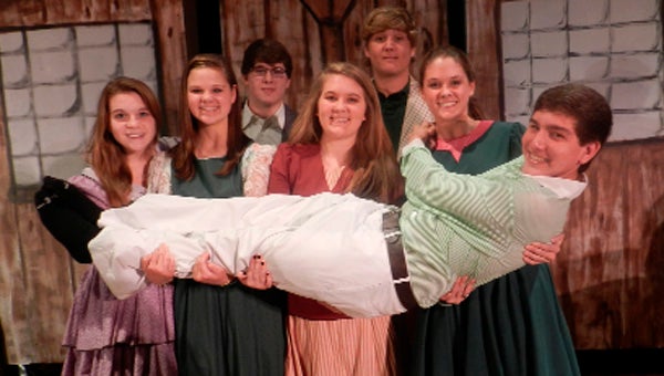 Student director Charlie Brock is held aloft by members of the cast.