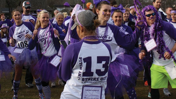 Some of the almost 60 members of Butch’s Braves warm up for last weekend’s Purplestride 5K in Birmingham. 
