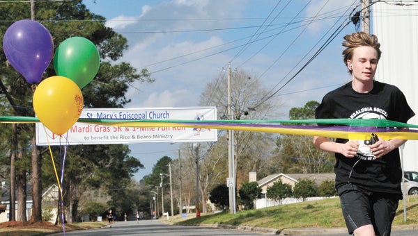 James Albritton crossed the finish line in 21 minutes, 12 seconds to finish as the fastest male runner in the St. Mary’s Mardi Gras 5K. | Andrew Garner/Star-News