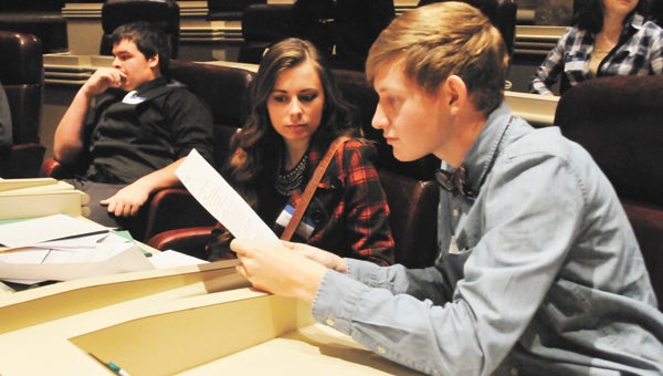 Florala seniors Caleb Zessin (far right), Katherine White and Tristan Petrey get settled in the Alabama State House of Representatives chamber Tuesday morning. |  Andrew Garner/Star-News