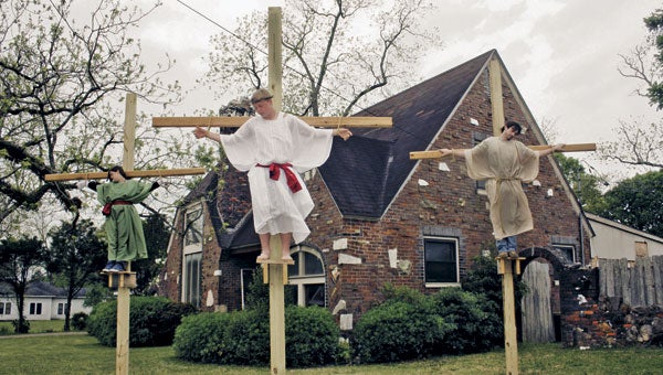 Members of Opp’s First Assembly of God  act out a live crucifixion scene in preparation for today’s day of remembrance of Good Friday and of Sunday’s Easter holiday. The scene will continue on Barnes Street today and Saturday from 4 to 5:30 p.m. Pictured are, from left, Aly Johnson, Eli Hattaway and Jacob Forbes. | Blake Bell/Star-News 