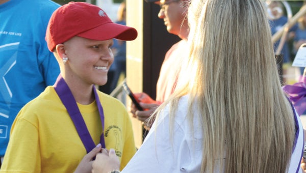 AHS senior Megan Kelley receives her medal just before the survivors' lap at Friday's Relay for Life event.
