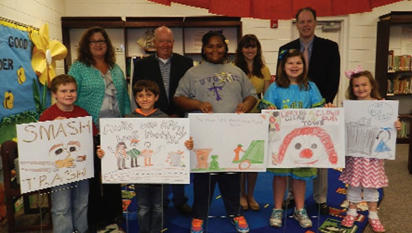 Courtland Williams, Carter Metcalf, Brooklyn Simpson, Olivia Lee Wise and Annaleigh Fischer (shown, front row, from left) were the winners in the city’s poster contest for its annual spring clean up week.  They are shown with (back row) principal Patty Taylor, Councilman Kennith Mount, Stephanie Moceri, and city clerk John Thompson. 