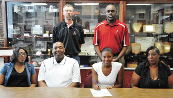 Shandricka Thompkins (bottom row second from right) signed a basketball scholarship with Lawson State Community College Friday morning. Thompkins is shown here with her mother, Lakeshia Suggs; aunt, Tamekia Hall; LSCC coach Aubrey Wiley; Andalusia principal Dr. Daniel Shakespeare; and AHS coach Brad Garner.