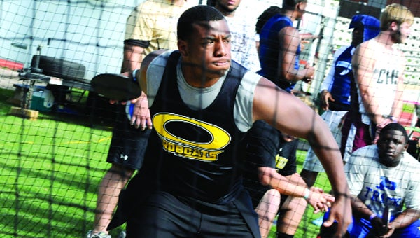 Opp High student Derek Savage competes in the discus event Friday at Memorial Stadium.  