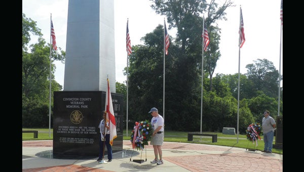John Vick places a wreath at the Veterans Memorial Saturday.