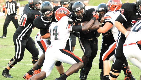 Andalusia senior running back Derrick Dorsey fights his way through T.R. Miller defenders in the first half of the Bulldogs' 38-15 loss Friday night.