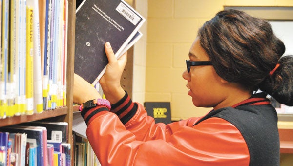 - Alexa Lindquist began organizing library books in the new AJHS Tuesday. 
