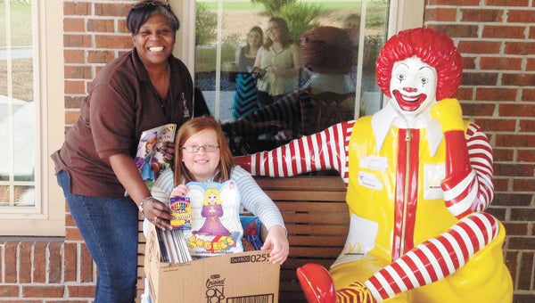 Annaclaire Harper is shown giving her donation at the Ronald McDonald House. |                       Courtesy photo