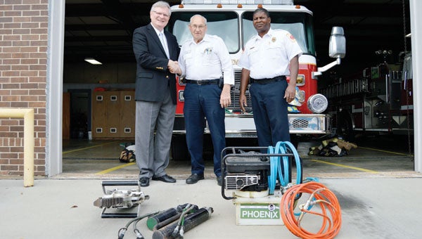 Haywood Nawlin, center, presented  Jaws of Life equipment to the AFD. He is shown with Mayor Earl Johnson and chief Ethan Dorsey. | Josh Dutton/ Star-News