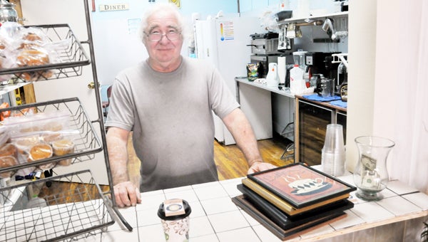 Joe's Barista co-owner Joe Davis poses behind his counter Monday afternoon. | Andrew Garner/Star-News