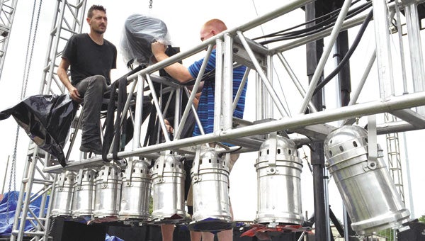 Michael Frank, BoBo Mathews and Eric Spranger of Life Wave Productions work on the stage lights for the Opp Rattlesnake Rodeo, which begins this morning at 8 at Channell-Lee Stadium. | Andrew Garnerr/Star-News