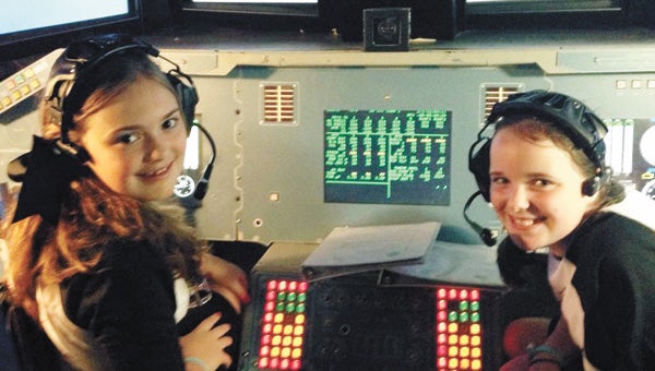  Sisters Adeline Fischer (left) and Carley Tillman (right) prepare for the shuttle mission. | Courtesy photo