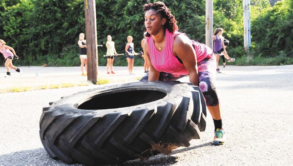 Reina Williams works out during the 5:30 Boot Camp Monday night behind the old Advanced EMS building. | Andrew Garner/Star-News