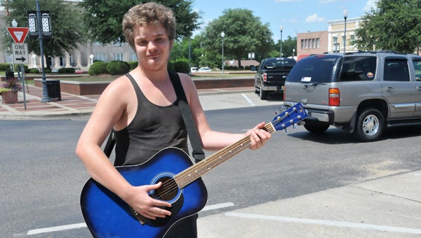 Jacob Moseley was seen on the Court Square on Monday playing his guitar. | Andrew  Garner/ Star-News
