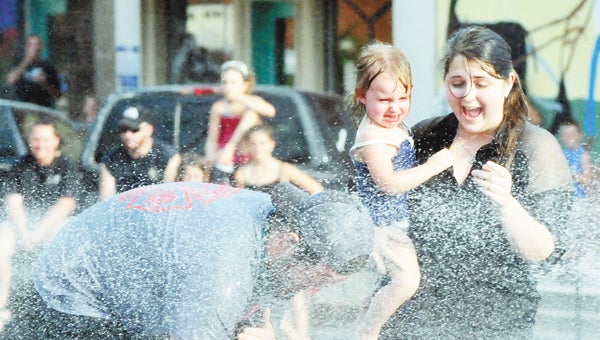 olks from around the county gathered to cool off at the annual Water Battle, part of the 145th Masonic Celebration in Florala. Above: Savannah Gibson and Allison Atkins take their turn.