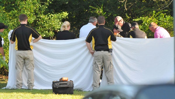 Opp and Covington County law enforcement officials investigate the scene where two were found dead Wednesday afternoon in Opp. | Andrew Garner/Star-News