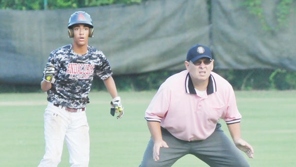 Umpire Ken Helms (right) officiates during the 14U All-Star District Championship game Thursday night in Andalusia. Helms has been an umpire for 18 years, and was selected as an official of the year by the AHSAA. | Andrew Garner/Star-News