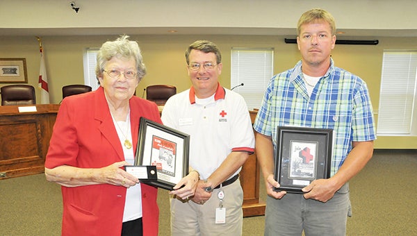 American Red Cross Executive Director Mike Brown (center) presents Kevin Kennedy (right) with the 2015 Disaster Services Volunteer of the Year Award, and Janice Castleberry (left) with the 2015 Blood Services Volunteer of the Year Award. | Andrew Garner/Star-News