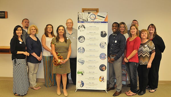 Andalusia Social Security Administration Employees Angie Wismer, Debbie Wibbing, Marc Lambert, Stephen Thomas, Judie Harrison, Maria Garcia, Nikki Inabinett, Mandy Watson, Nancy Nichols, Dianne Brown, Tremayne Benson and Randy Wahl pose for a picture around the SSA’s sign celebrating the program’s 80th anniversary. | Andrew Garner/Star-News 