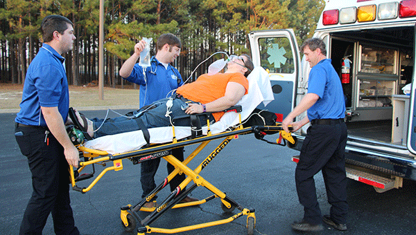 Students demonstrate loading a patient in an ambulance. Courtesy photo