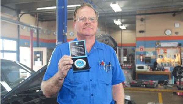 LBW Community College Automotive Mechanic Faculty Richard McCuistian holds the medallion recognizing 25 years as an Automotive Service Excellence (ASE) certified technician.